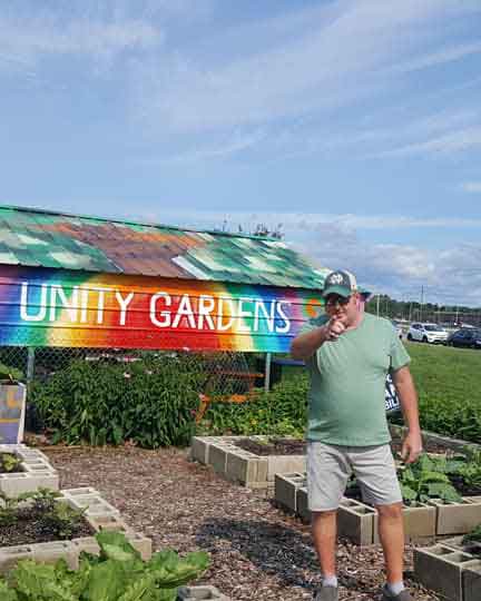 Photo of Derek Bilski "Dirty Bil" Standing in Unity Gardens